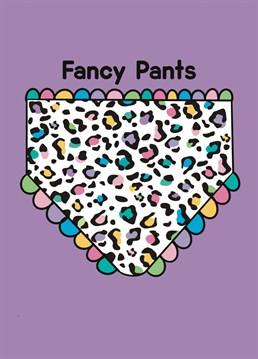 A pair of leopard print pants with pastel rainbow frilly edge and the words Fancy Pants on a purple background.