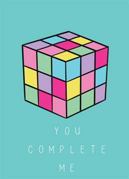 Large rubber cube in pastel colours with you complete me underneath and a bold background.