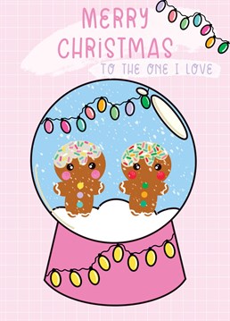Snow globe with a gingerbread couple inside. A beautiful Christmas card to send to loved ones this festive season