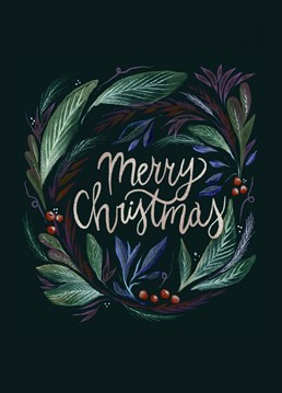 This Christmas card features a hand drawn beautiful and decorative wreath around hand lettering Merry Christmas.
