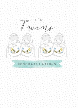 Baby card from Laura Darrington Design featuring two pair of baby shoes with floral patterns, above the caption reads "It's Twins Congratulations!" all on a spotty background.