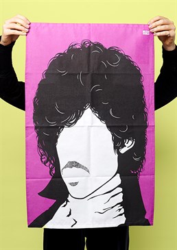 Washing up in the purple rain! Celebrate a legendary musician Dry the dishes in style Illustrated silhouette design Iconic big hair and ruffle shirt look This is what it looks like when dishes dry... The one and only Prince is emblazoned in stunning fashion on this novelty tea towel. Inject a splash of colour and style into the most mundane of tasks, with this recognisable black and white silhouette on a purple (obvs) background. Keep the memory of Prince alive, whack on some of his greatest hits and you won't even mind that you're still standing at the sink half an hour later. This is a must-have, and very practical gift for any Prince fan that'd look amazing displayed in the home.  New In For Her Home Decor