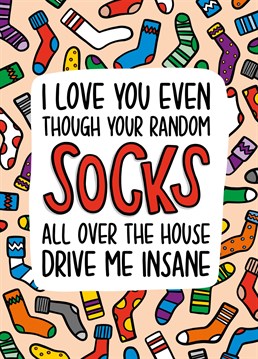 This socks Valentines Day Card features a background covered in all different types of socks with the phrase "I love you even though your random socks all over the house drive me insane".